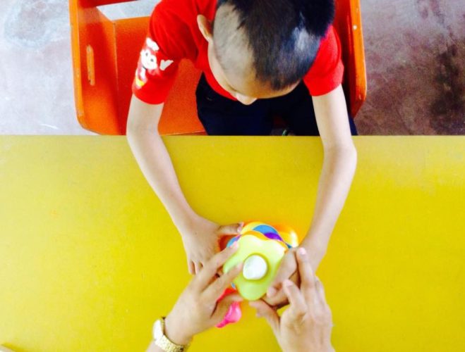 The Special Education teacher doing one-on-one with a visually impaired child.